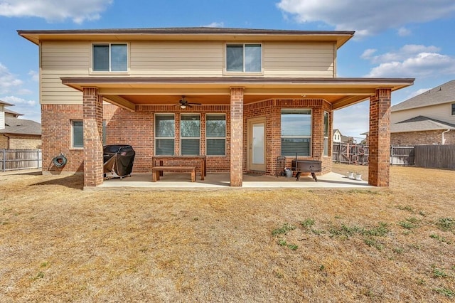 back of house with a ceiling fan, a patio area, brick siding, and a fenced backyard