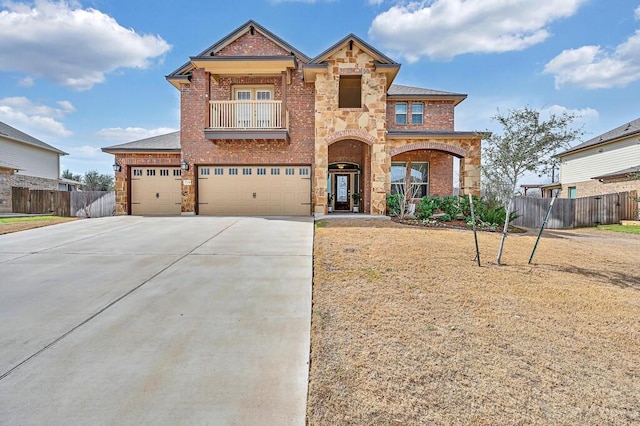 view of front of home with a balcony, driveway, fence, and brick siding