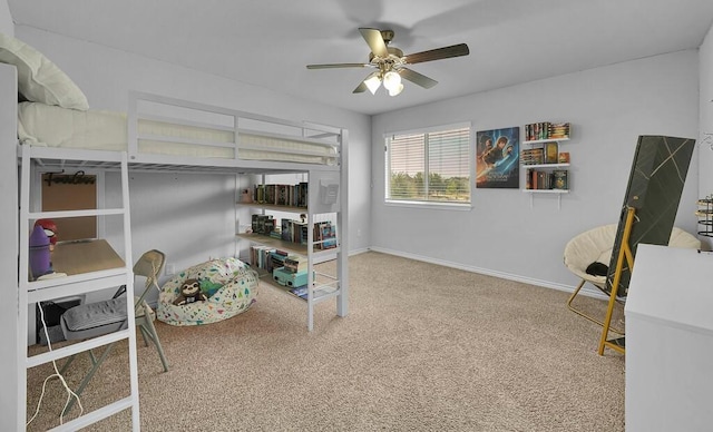 carpeted bedroom featuring baseboards and a ceiling fan