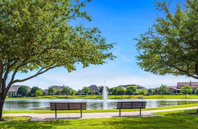 surrounding community featuring a lawn, a water view, and a residential view