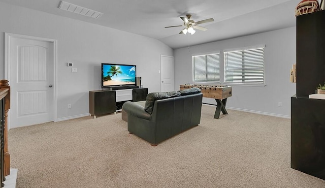 living area with light carpet, baseboards, visible vents, and lofted ceiling