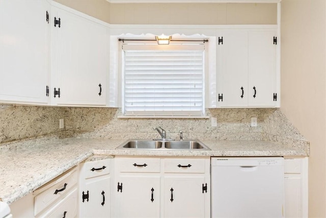 kitchen featuring sink, white cabinets, and white dishwasher