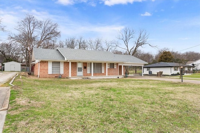 ranch-style home featuring a porch and a front lawn