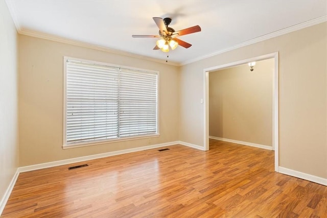 spare room with crown molding, ceiling fan, and light wood-type flooring