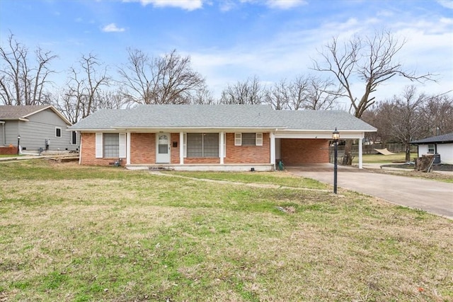 single story home featuring a carport and a front lawn