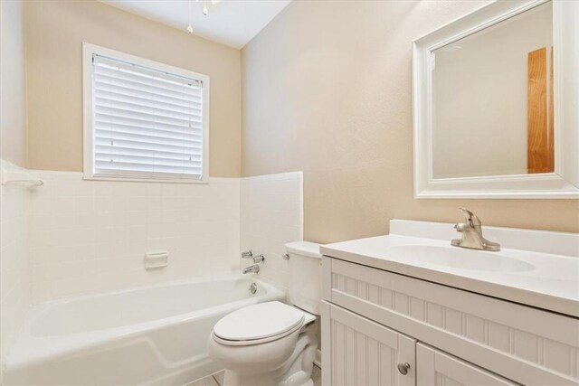 bathroom with vanity, a bathtub, and toilet