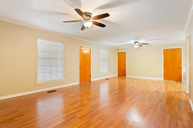 spare room with crown molding, ceiling fan, and light wood-type flooring