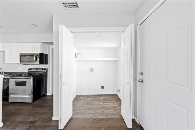 laundry room featuring dark wood-type flooring