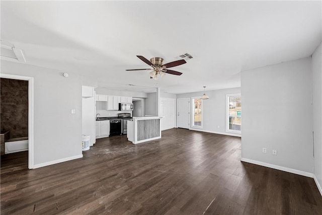 unfurnished living room with sink, dark wood-type flooring, and ceiling fan