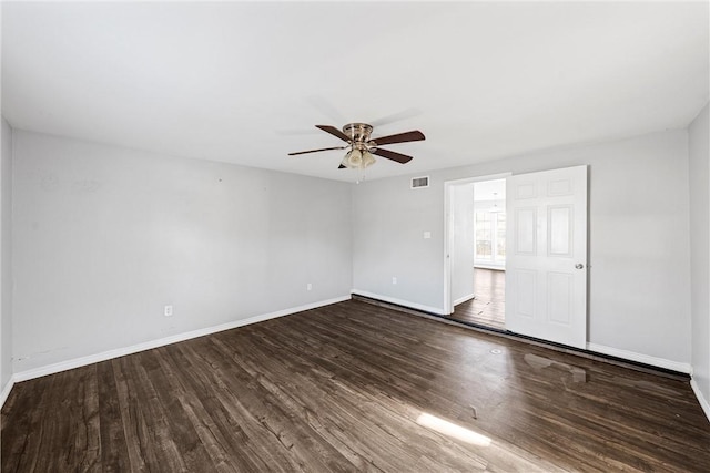 spare room with dark hardwood / wood-style flooring and ceiling fan