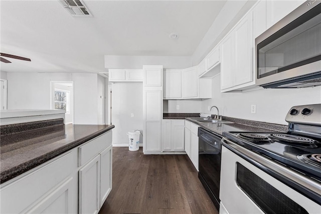 kitchen with sink, dark wood-type flooring, ceiling fan, white cabinetry, and stainless steel appliances