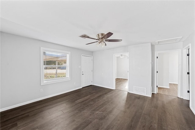 spare room with dark hardwood / wood-style flooring and ceiling fan