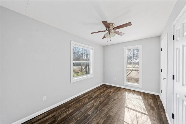 unfurnished bedroom featuring ceiling fan and dark hardwood / wood-style flooring