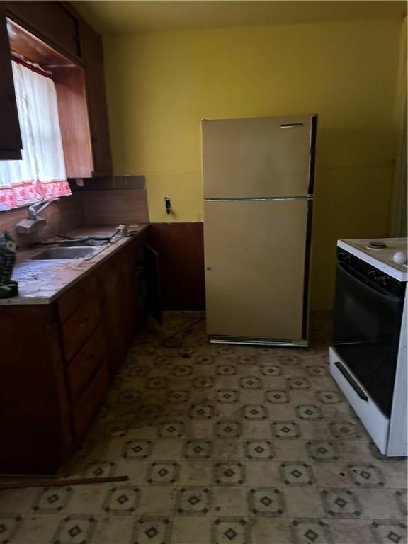 kitchen featuring white appliances and sink