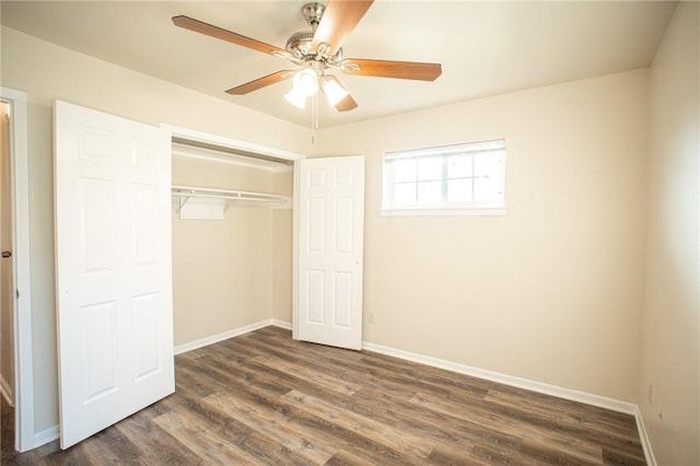 unfurnished bedroom featuring dark wood-type flooring, ceiling fan, and a closet