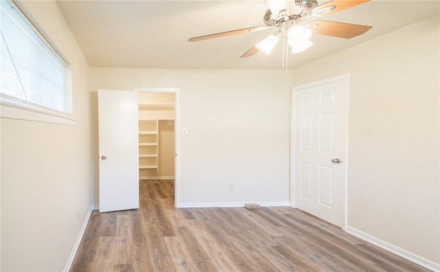 empty room with hardwood / wood-style flooring and ceiling fan