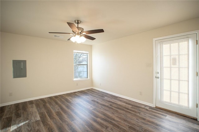 spare room featuring electric panel, dark hardwood / wood-style floors, and ceiling fan