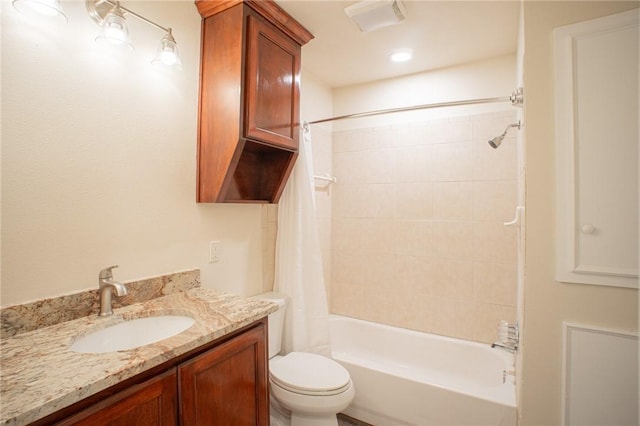 full bathroom featuring vanity, shower / tub combo with curtain, and toilet