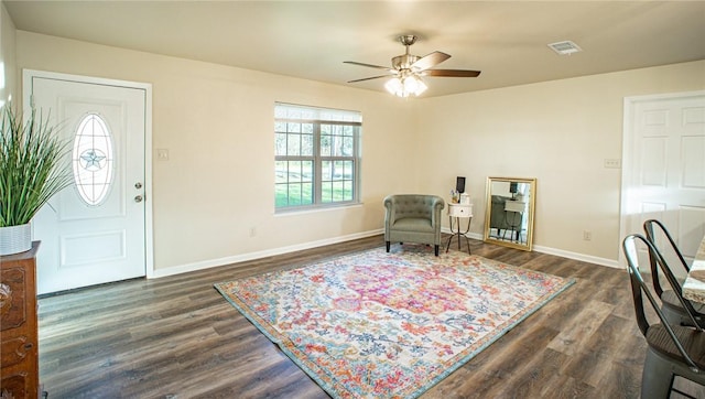 sitting room featuring dark wood-type flooring and ceiling fan