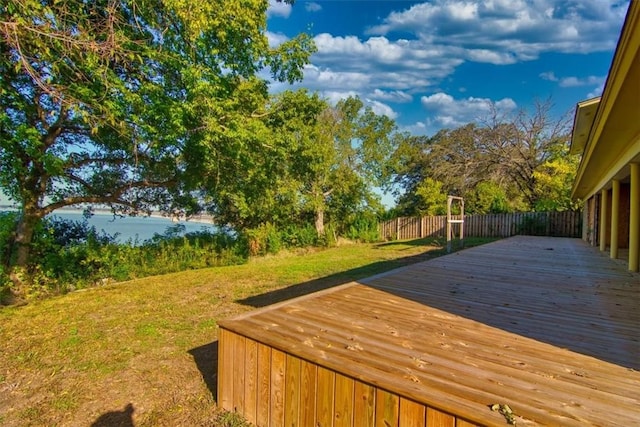 wooden terrace featuring a yard and a water view