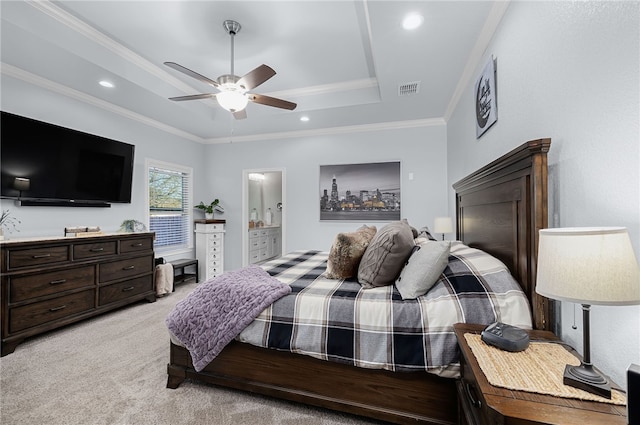 bedroom featuring ensuite bath, ceiling fan, crown molding, a tray ceiling, and light carpet