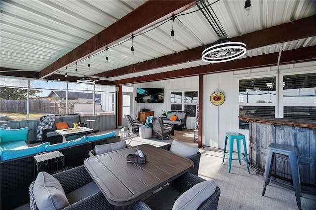 view of patio / terrace with an outdoor living space, a jacuzzi, and exterior bar