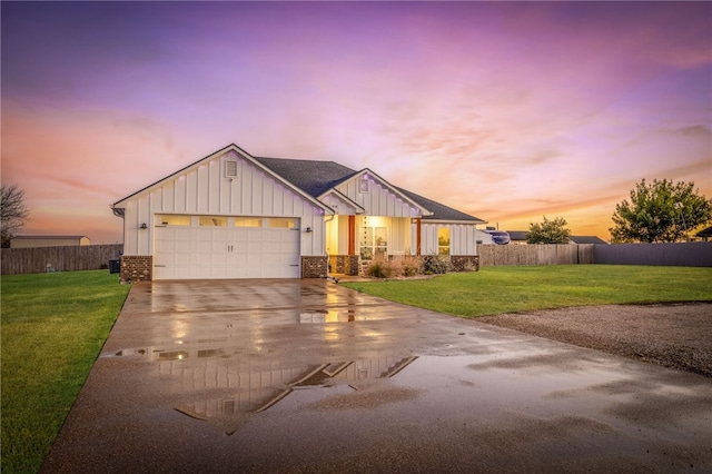 view of front of property featuring a yard and a garage