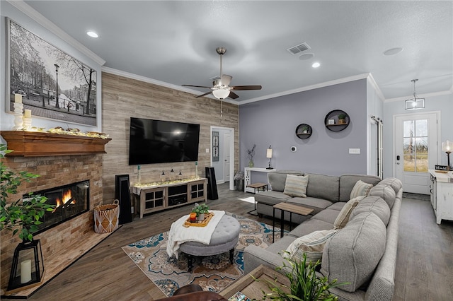 living room with dark hardwood / wood-style flooring, a brick fireplace, ceiling fan, and ornamental molding