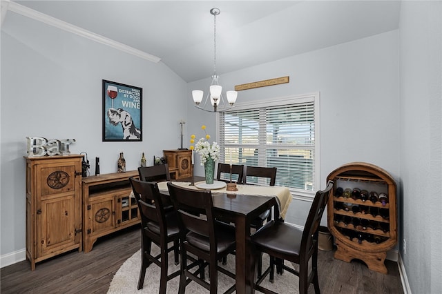 dining area featuring dark hardwood / wood-style floors, vaulted ceiling, crown molding, and a chandelier