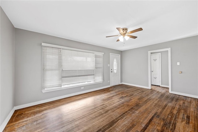 spare room with dark hardwood / wood-style flooring and ceiling fan