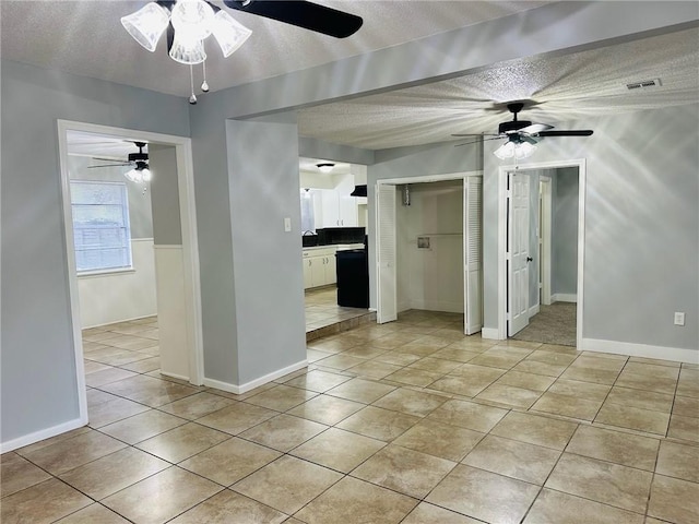 tiled spare room with a textured ceiling