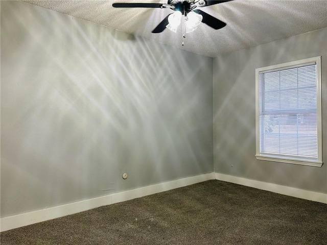 carpeted empty room featuring ceiling fan and a textured ceiling