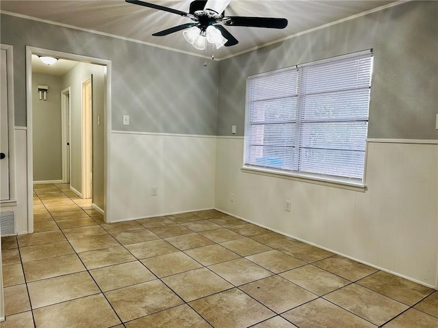 spare room with ceiling fan and crown molding