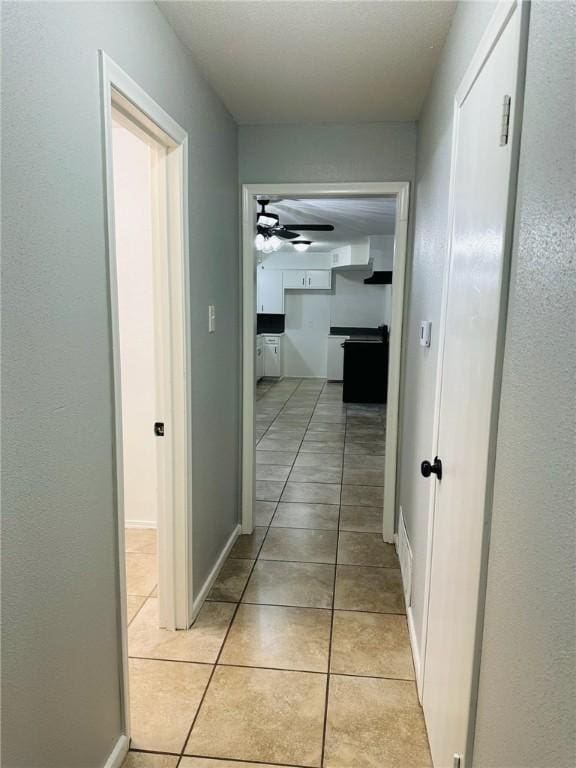 corridor with light tile patterned floors