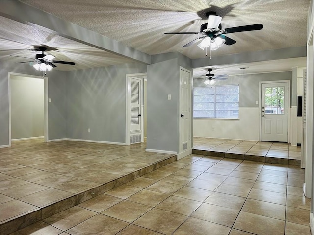 interior space featuring light tile patterned floors and a textured ceiling