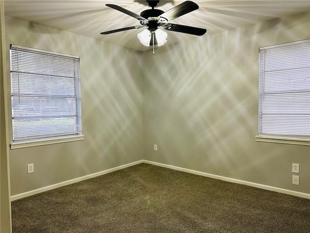 unfurnished room featuring ceiling fan and dark colored carpet