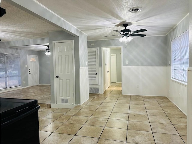 interior space featuring ceiling fan and a textured ceiling