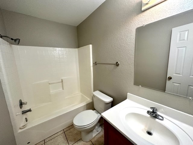 full bathroom featuring vanity, bathtub / shower combination, tile patterned flooring, toilet, and a textured ceiling