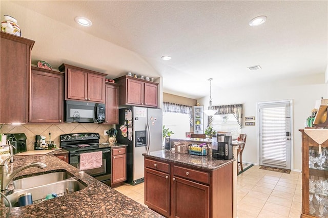 kitchen featuring lofted ceiling, sink, decorative light fixtures, black appliances, and backsplash