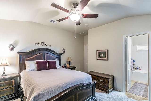 bedroom featuring lofted ceiling, connected bathroom, light colored carpet, and ceiling fan