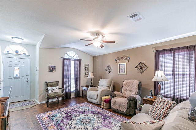 living room with ceiling fan, plenty of natural light, dark hardwood / wood-style floors, and vaulted ceiling