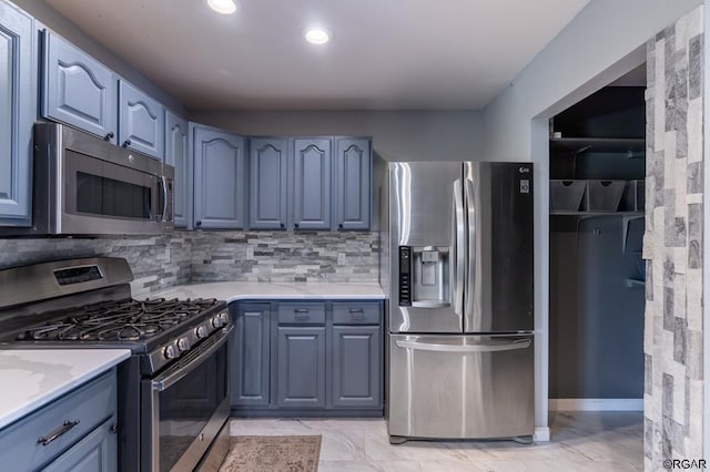 kitchen with appliances with stainless steel finishes and backsplash