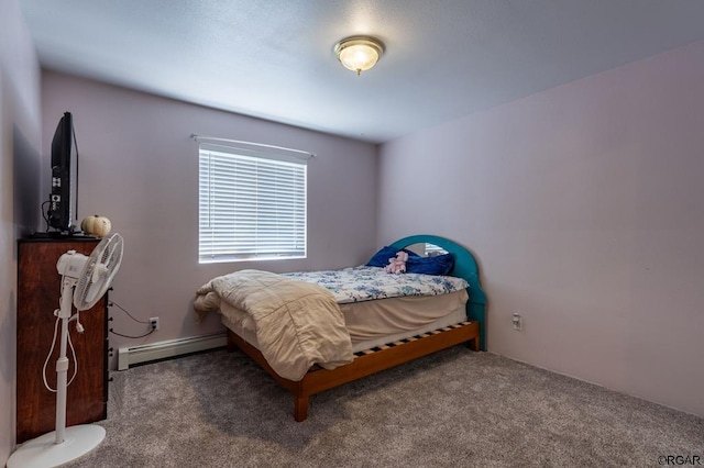 bedroom with baseboard heating and carpet