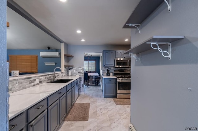 kitchen featuring sink, a wall mounted air conditioner, gray cabinets, stainless steel appliances, and backsplash