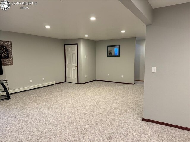 interior space featuring light colored carpet and baseboard heating