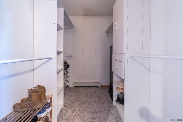 walk in closet featuring light colored carpet and baseboard heating