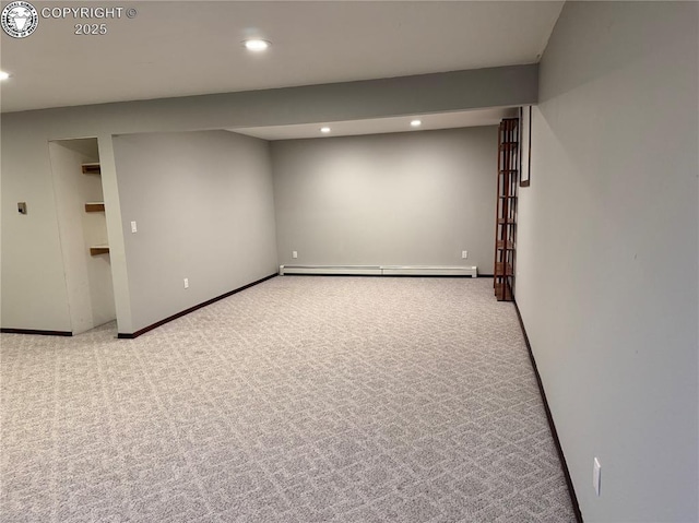 basement featuring light carpet and baseboard heating