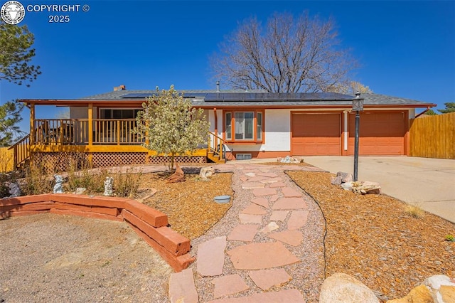 2114 Rangeview Dr, Pueblo, CO 81008 - view of front of house with concrete driveway, roof mounted solar panels, a garage, and covered porch