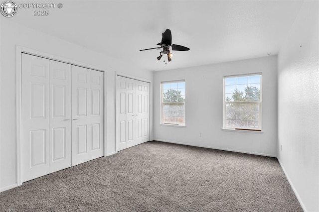 121 Mourning Dove Dr, Canon City, CO 81212 - unfurnished bedroom with two closets, carpet, and a ceiling fan