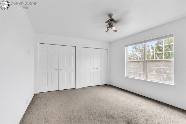 121 Mourning Dove Dr, Canon City, CO 81212 - unfurnished bedroom featuring carpet flooring, multiple closets, and a ceiling fan